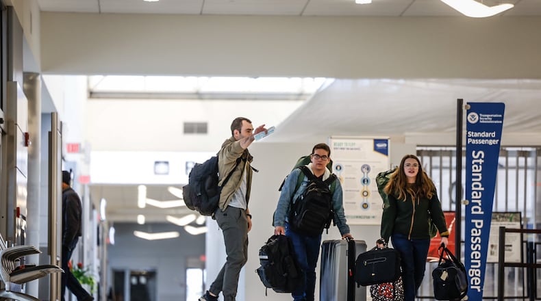 Traveler at the Dayton International Airport walk to the TSA checkpoint Friday November 18, 2022. Jim Noelker/Staff