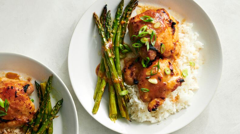 This photo shows Miso-Honey Chicken and Asparagus, a quick and easy sheet-pan meal that is broiled instead of baked, which chars the marinade slightly on the chicken, browns the asparagus for maximum flavor and cuts the cooking time to around 10 minutes.  (David Malosh/The New York Times)