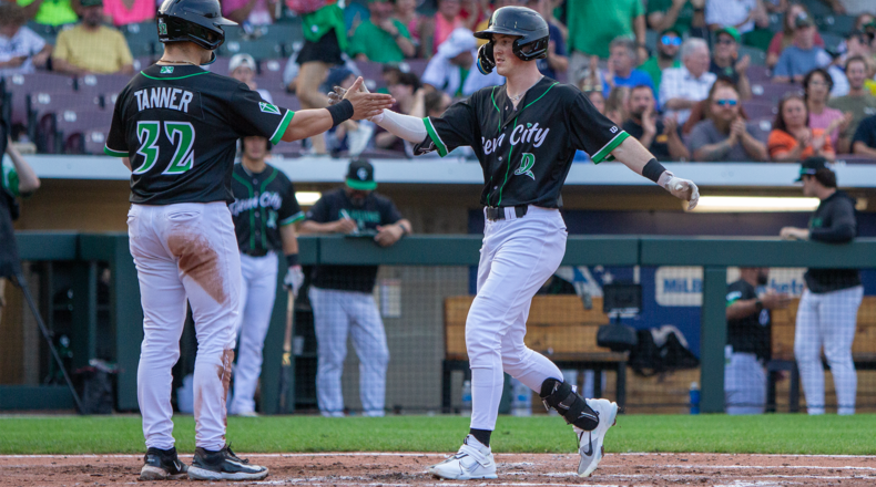 Ethan O'Donnell is greeted at home plate by Logan Tanner after hitting a two-run homer that gave the Dragons the lead in the fourth inning Wednesday night at Day Air Ballpark. Jeff Gilbert/CONTRIBUTED