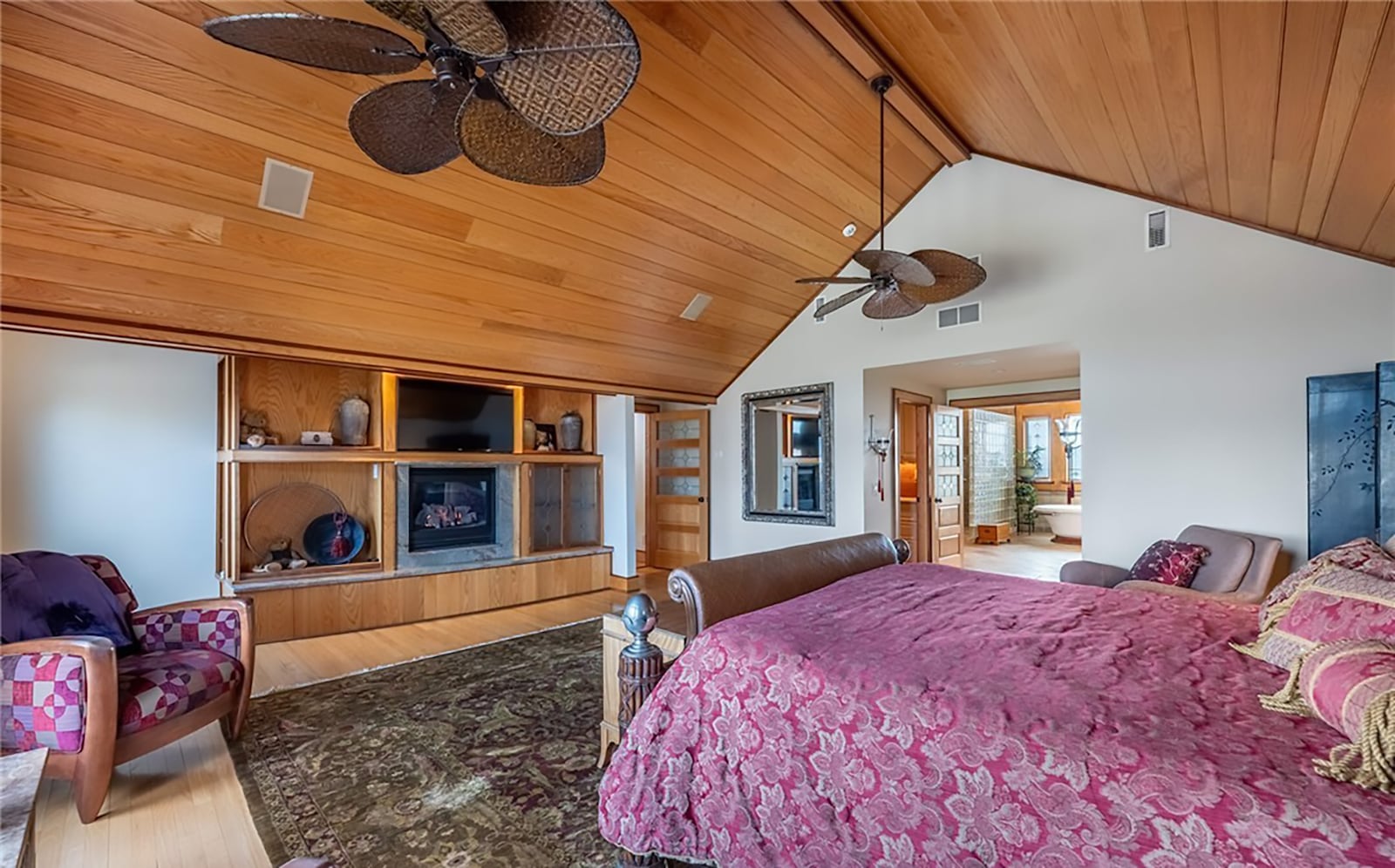 The primary bedroom suite is in the addition on the second level. It has hardwood floors, a wood vaulted ceiling and two ceiling fans. It also has a built-in entertainment center with lights and a gas fireplace. CONTRIBUTED