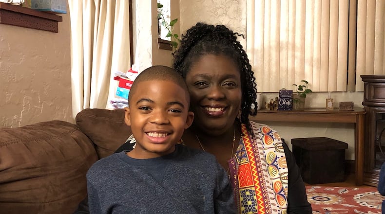 Tonya Whatley and her grandson Calell are enjoying the Christmas season in their Dayton home. JEREMY P. KELLEY / STAFF