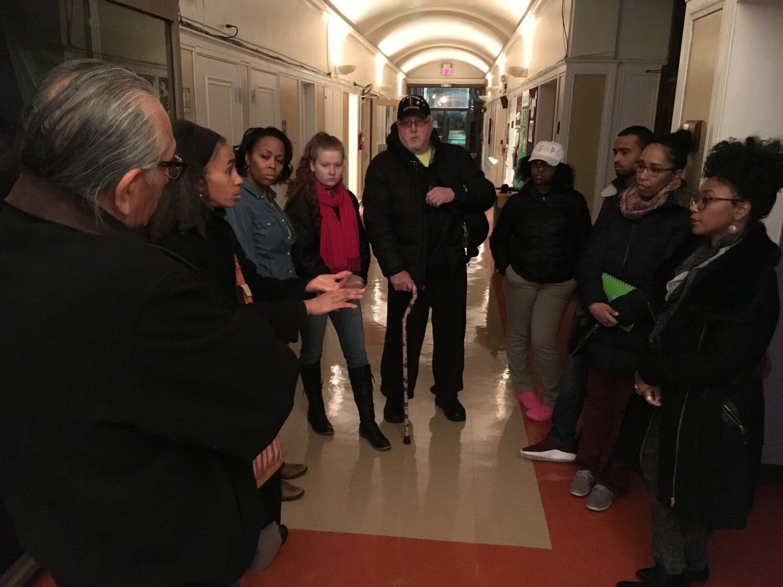 Residents from neighborhoods around Good Samaritan Hospital stand in the hallway of Omega Baptist Church during a recent community meeting sharing their reactions to plans to close the hospital this year.
