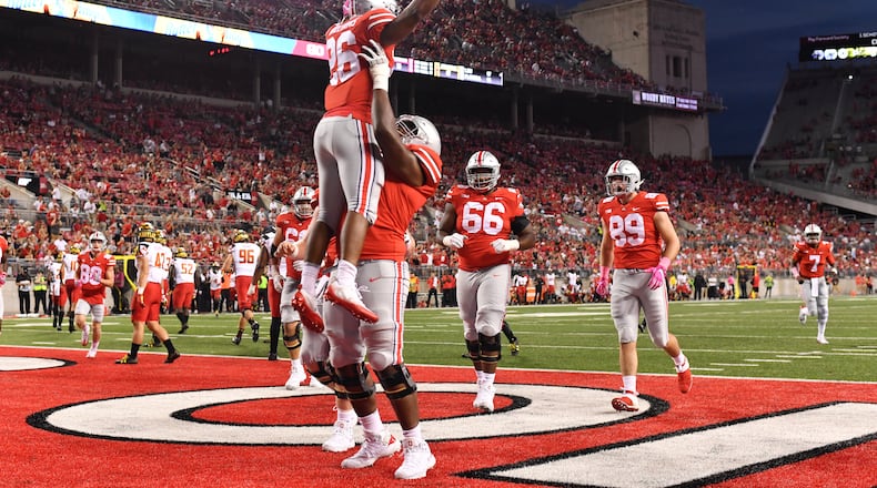 COLUMBUS, OH - OCTOBER 7: Antonio Williams #26 of the Ohio State Buckeyes celebrates in the end zone with Thayer Munford #75 of the Ohio State Buckeyes after scoring on an eight-yard touchdown run in the fourth quarter against the Maryland Terrapins at Ohio Stadium on October 7, 2017 in Columbus, Ohio. Ohio State defeated Maryland 62.14. (Photo by Jamie Sabau/Getty Images)