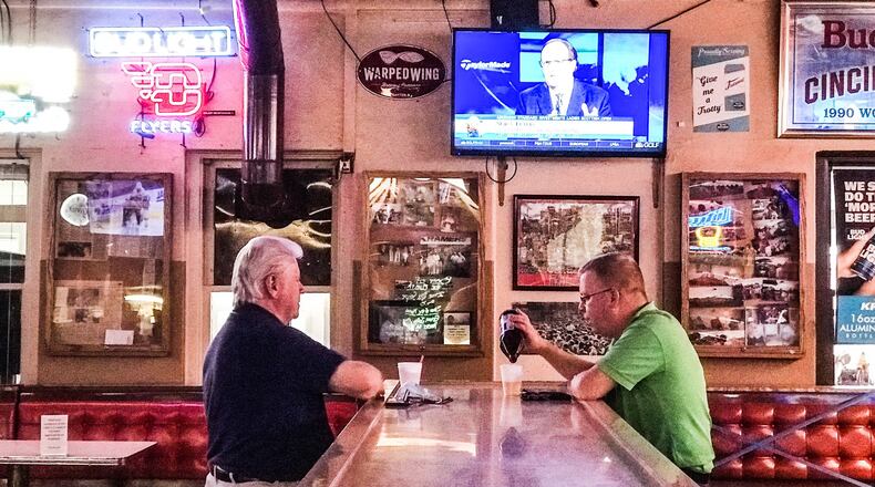 Marlin Younce, left and Andy Good, both from Dayton, enjoy each other's company and the baseball game at Kramer's Tavern on Irving Ave. near the University of Dayton. The COVID-19 pandemic has cut into business and cancellation of most college sports will amplify the impact. JIM NOELKER/STAFF