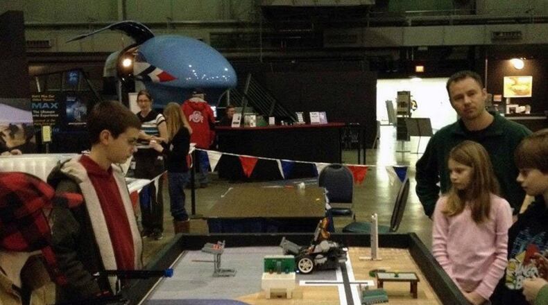 Representatives from the Dayton STEM School explain different concepts of robotics to visitors during Family Day at National Museum of the U.S. Air Force. January’s Family Day at the museum provides fun demonstrations and hands-on activities in the exiting field of robotics. (U.S. Air Force photo)