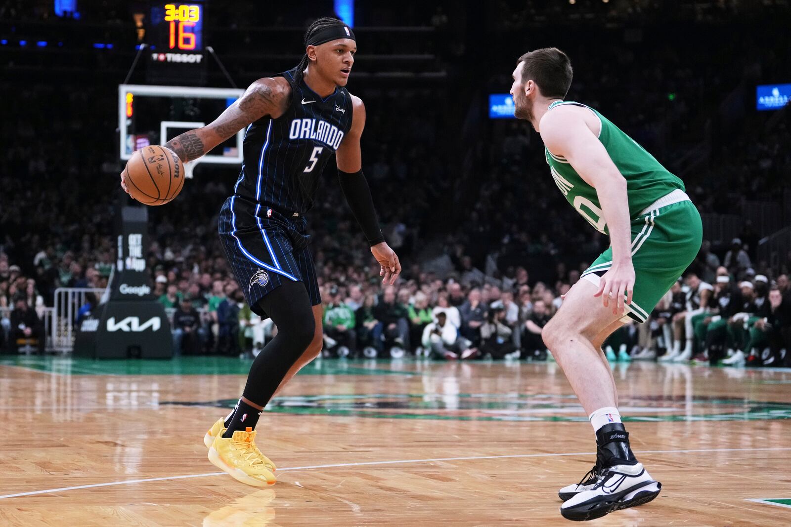 Orlando Magic forward Paolo Banchero (5) drives to the basket against Boston Celtics center Luke Kornet, right, during the first half in game 2 of a first-round NBA playoff basketball series, Wednesday, April 23, 2025, in Boston. (AP Photo/Charles Krupa)