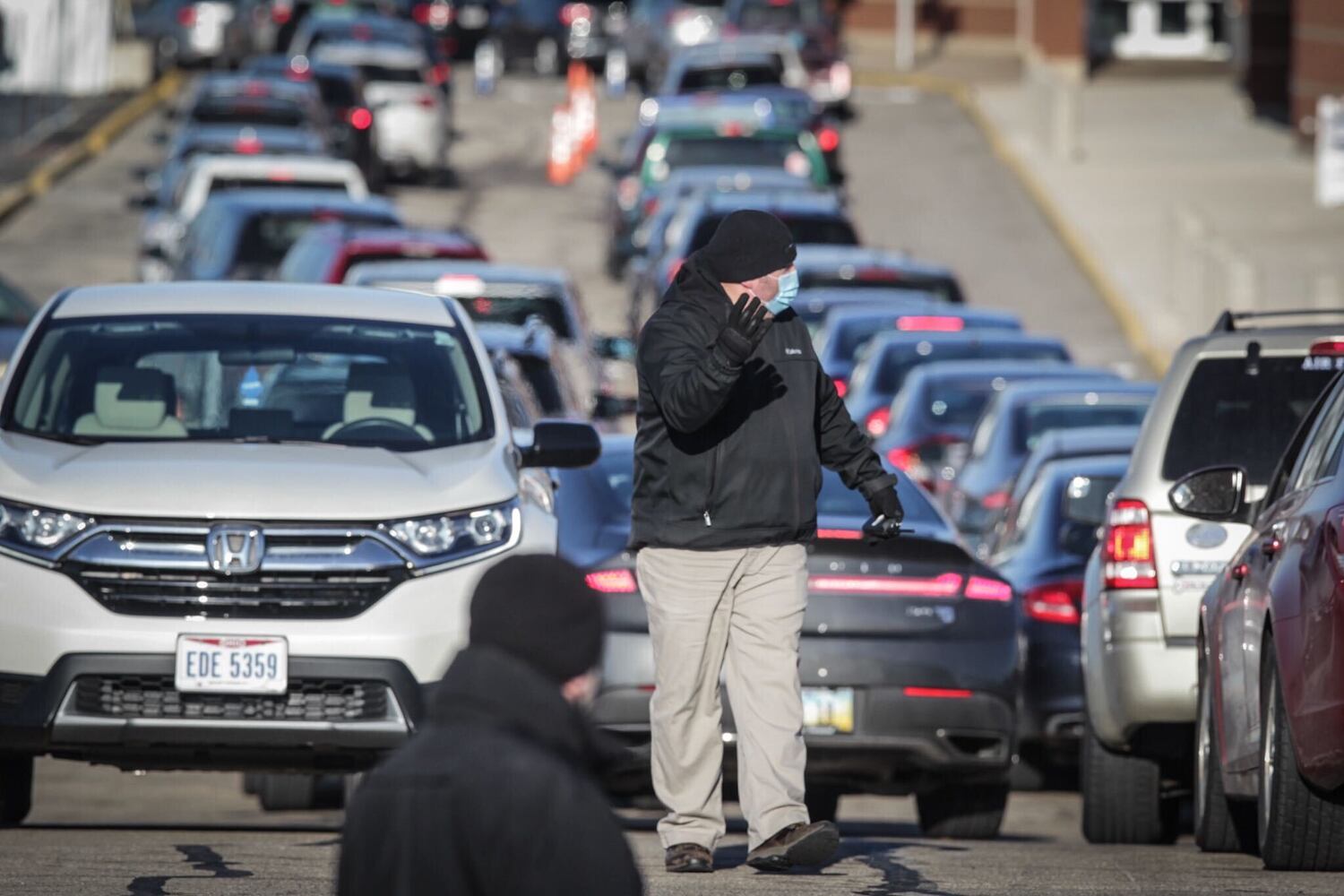 Cars line up for a coronavirus vaccine clinic at UD Arena