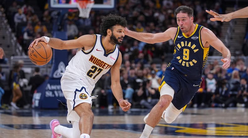 Denver Nuggets guard Jamal Murray (27) drives on Indiana Pacers guard T.J. McConnell (9) during the second half of an NBA basketball game in Indianapolis, Wednesday, Dec. 3, 2025. (AP Photo/Michael Conroy)