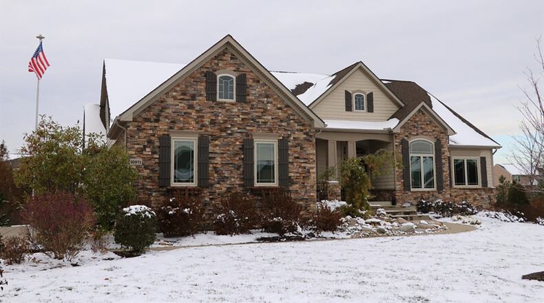 The stone-and-plank ranch has about 5,360 sq. ft. of living space. The oversized, 3-car garage has a workshop nook and a wall of built-in cabinets. CONTRIBUTED PHOTOS BY KATHY TYLER