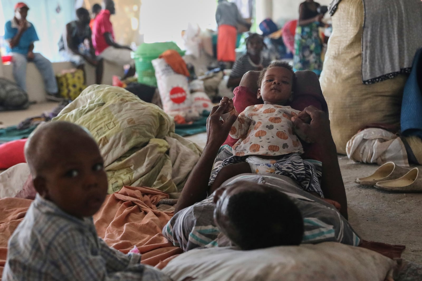 People displaced by gang violence gather inside a nightclub being used as a shelter in the Petion-Ville neighborhood of Port-au-Prince, Haiti, Monday, July 21, 2025.(AP Photo/Odelyn Joseph)
