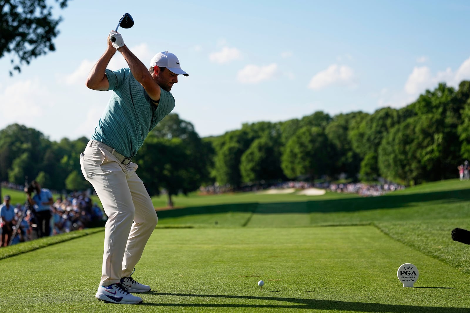Scottie Scheffler hits his tee shot on the 15th hole during the third round of the PGA Championship golf tournament at the Quail Hollow Club, Saturday, May 17, 2025, in Charlotte, N.C. (AP Photo/David J. Phillip)