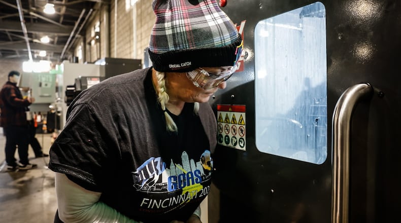 Sinclair College CNC  student Missy Haskell learns to operate a computerized lathe Wednesday December 4, 2024. Haskell is an employee of Metallus in Eaton and she is taking advanced classes at Sinclair. JIM NOELKER/STAFF