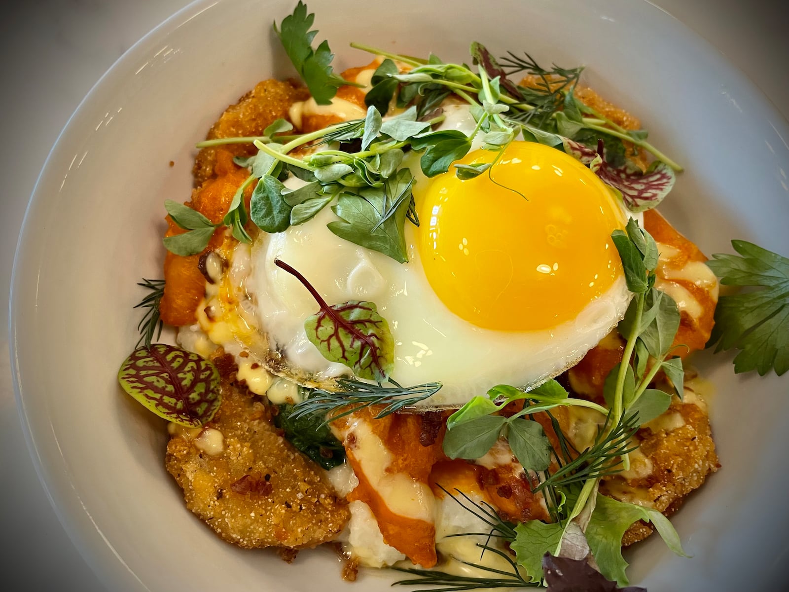 Calzada’s Kitchen, a family with more than a decade of experience working at Carillon Historical Park in Dayton, is now operating Culp’s Café. Pictured is the Loaded Shrimp & Grits Bowl. NATALIE JONES/STAFF