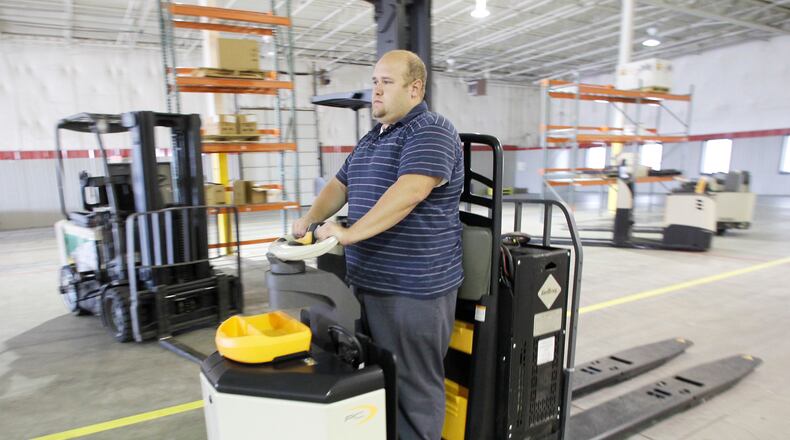 Steve Jutte, lead service technician at Crown Equipment Corporation’s Huber Heights Project Center, operates a hydrogen fuel cell-powered pallet truck in this 2010 file photo. FILE