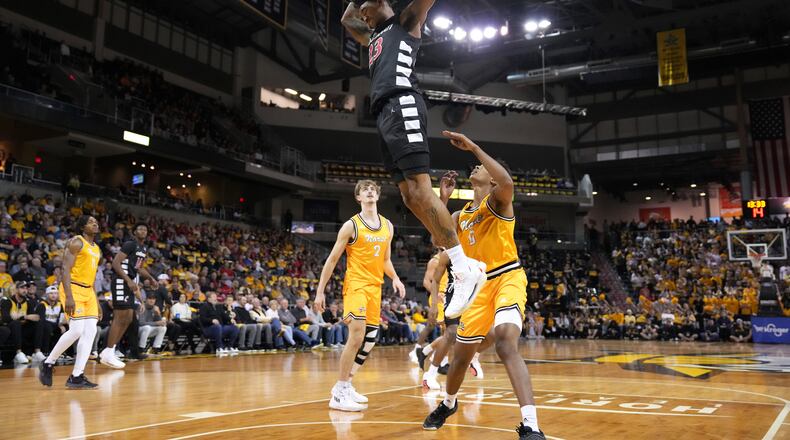 Cincinnati's Dillon Mitchell dunks against Northern Kentucky during the first half of an NCAA college basketball game, Tuesday, Nov. 19, 2024, in Highland Heights, Ky. (AP Photo/Kareem Elgazzar)
