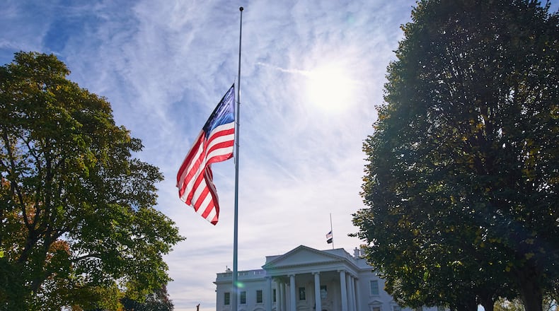 The American flag is seen at half-staff, Tuesday, Nov. 4, 2025, at the White House in Washington. (AP Photo/Jacquelyn Martin)