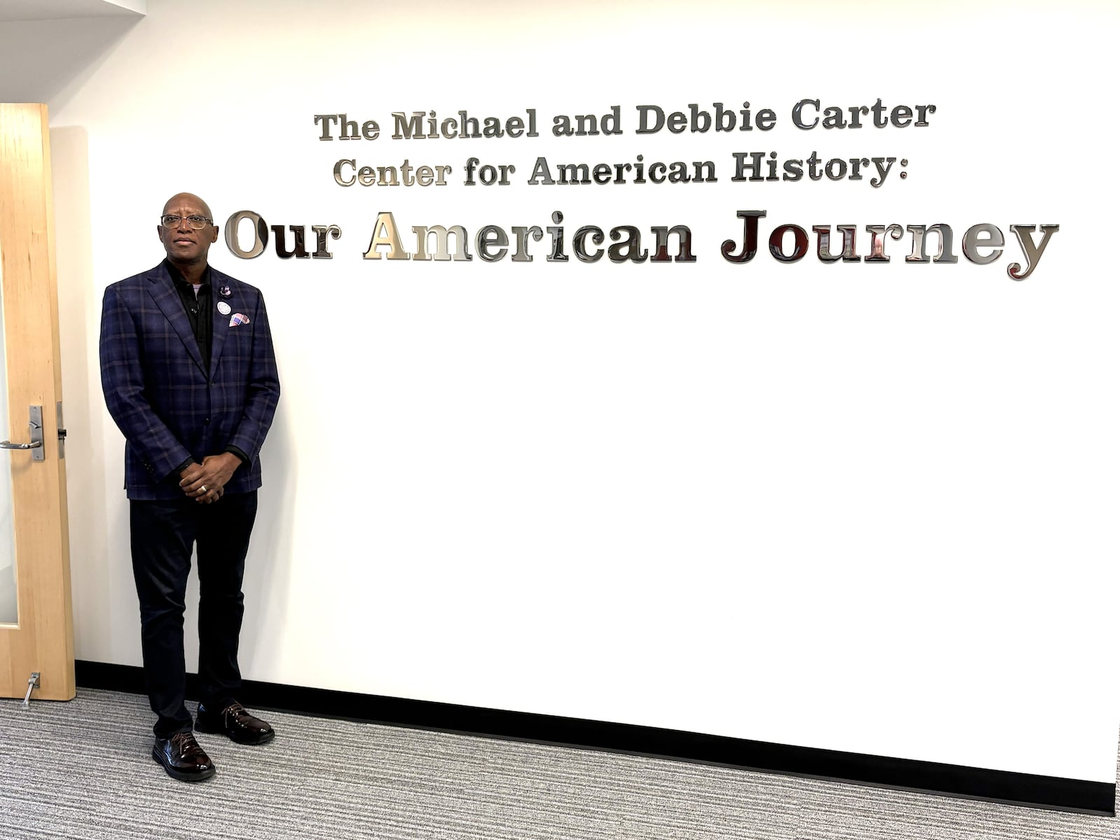 Michael Carter stands outside the “Michael and Debbie Carter Center for American History: Our American Journey” on the third floor of Building 11 at Sinclair Community College. The wonderful exhibit of African American-related memorabilia, photos and artifacts– sometimes disturbing, often celebratory and always thought-provoking – is free and open to the public. It is worth the time of a visit. TOM ARCHDEACON / CONTRIBUTED PHOTO