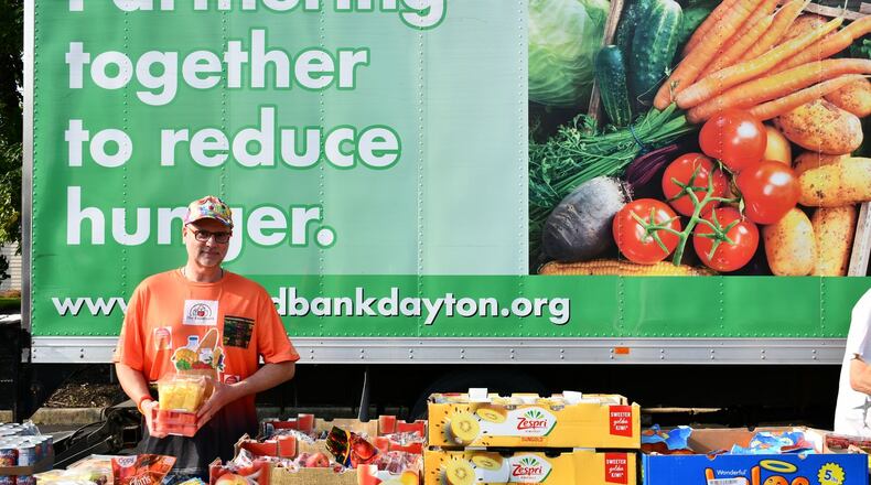 The Foodbank volunteer Jey Ellis helps set up a mobile pantry distribution. CONTRIBUTED