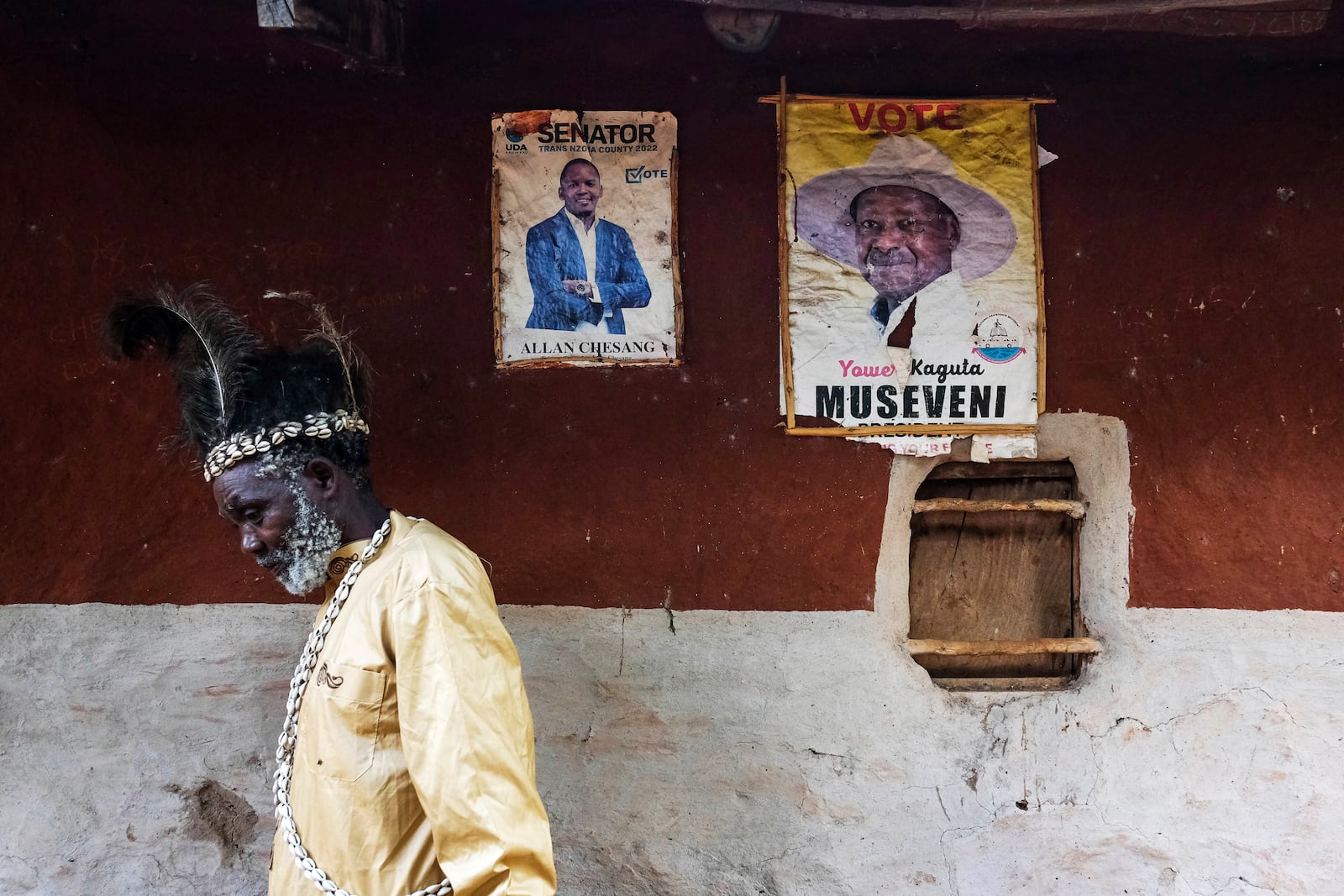 Seer Atukung Tafala, left, walks around his igloo-like shrine in Kampala, Uganda Saturday, June 21, 2025.(AP Photo/Hajarah Nalwadda)