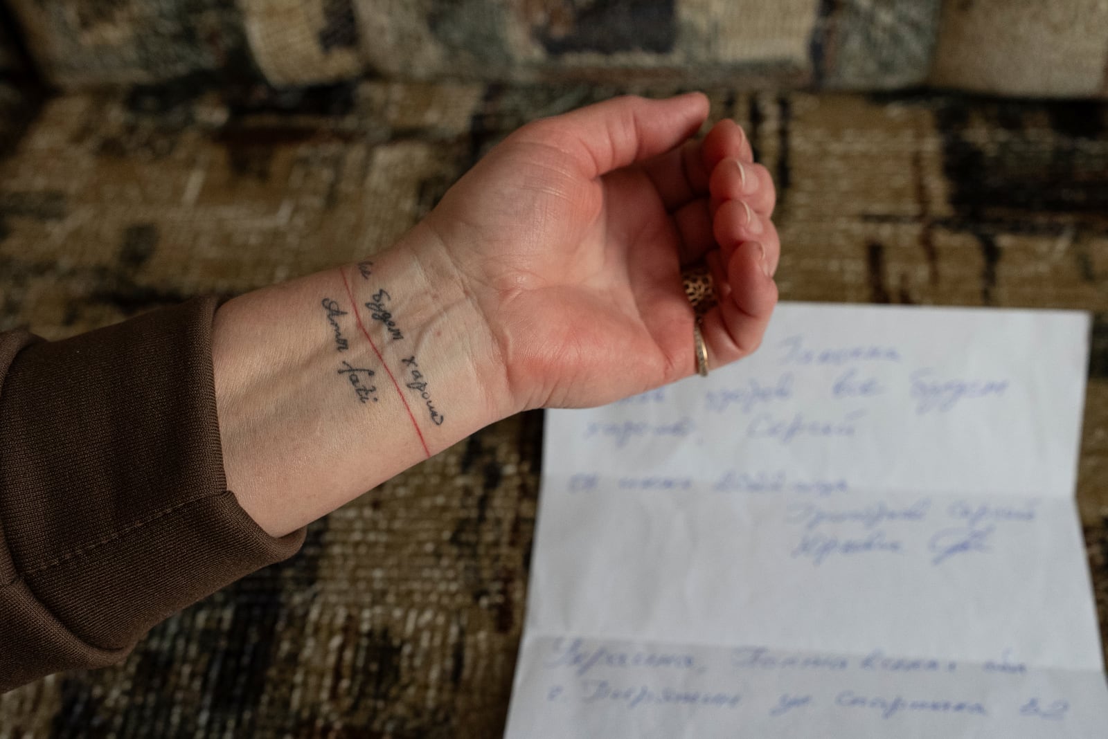 Halyna Hryhorieva of Pyriatyn, Ukraine, shows her tattoo of words often spoken by her husband, who was a prisoner of war in Russia: "Everything will be all right," on March 9, 2025. (AP Photo/Alex Babenko)