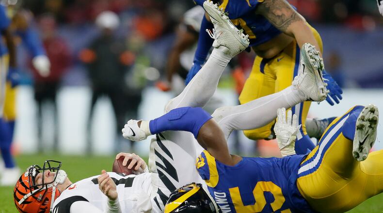 Cincinnati Bengals quarterback Andy Dalton, left, is sacked by Los Angeles Rams linebacker Obo Okoronkwo during the second half of an NFL football game, Sunday, Oct. 27, 2019, at Wembley Stadium in London. (AP Photo/Tim Ireland)