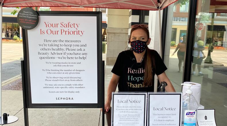 Sephora employee running a sanitization station for customers as they come in and leave the store. Cosette Gunter/ Staff Photo
