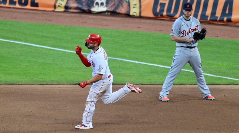 Mike Moustakas, of the Reds, celebrates after a home run on Opening Day against the Tigers on Friday, July 24, 2020, at Great American Ball Park in Cincinnati.