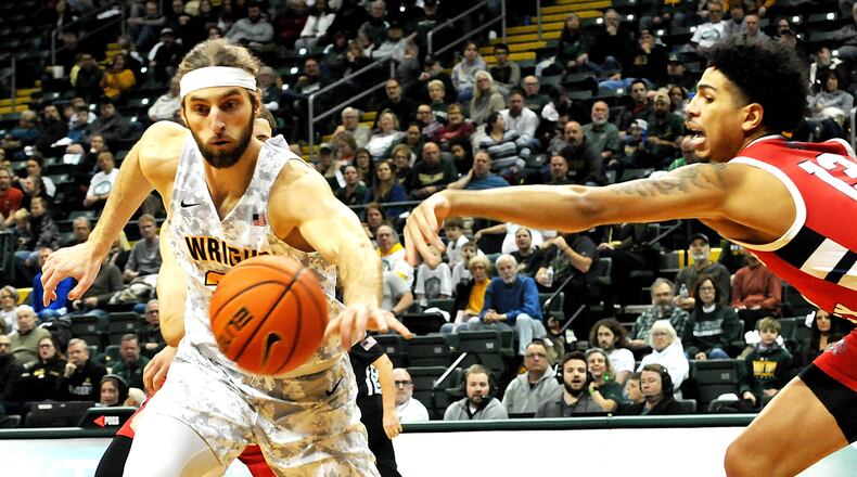 Wright State's Tim Finke, 24, and Detroit Mercy's Isaiah Jones, 13, go after a loose ball during the first half of a Horizon League game at the Nutter Center on Friday, Jan. 6. DAVID A. MOODIE/CONTRIBUTING PHOTOGRAPHER