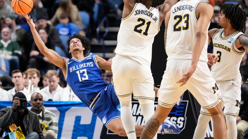 Saint Louis guard Dion Brown (13) attempts to shoot as he falls during the second half against Michigan in the second round of the NCAA college basketball tournament, Saturday, March 21, 2026, in Buffalo, N.Y. (AP Photo/Yuki Iwamura)