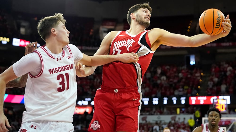 Ohio State center Ivan Njegovan, right, rebounds the ball against Wisconsin forward Nolan Winter (31) during the first half of an NCAA college basketball game Saturday, Jan. 31, 2026, in Madison, Wis. (AP Photo/Kayla Wolf)