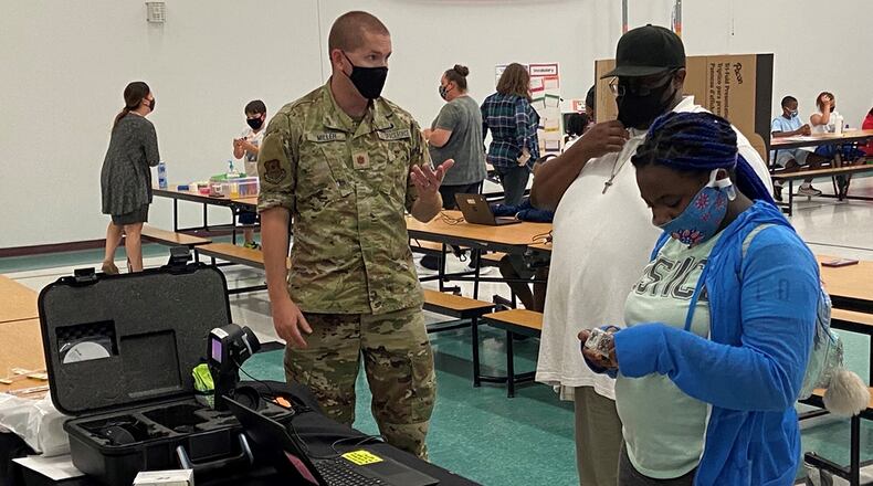 Maj. Daniel Miller, an Air Force Institute of Technology student, explains how the new Air Force Research Laboratory cubelets work to a student and her parent during North Dayton School of Discovery’s first STEM night Sept. 16. CONTRIBUTED PHOTO