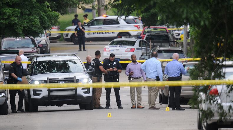 Dayton police closed off two blocks of Manhattan Ave. Friday morning after a fatal shooting. MARSHALL GORBYSTAFF