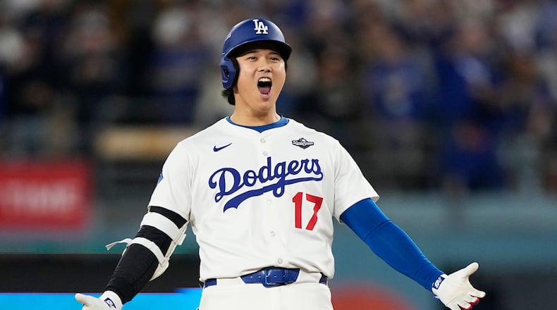 Los Angeles Dodgers' Shohei Ohtani celebrates hit RBI-Double against the Toronto Blue Jays during the fifth inning in Game 3 of baseball's World Series, Monday, Oct. 27, 2025, in Los Angeles. (AP Photo/Brynn Anderson)