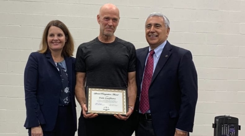 Dan Loofboro, who works with the Building Bridges program, is flanked by Montgomery County Juvenile Court Judges Helen Wallace and Anthony Capizzi. CONTRIBUTED