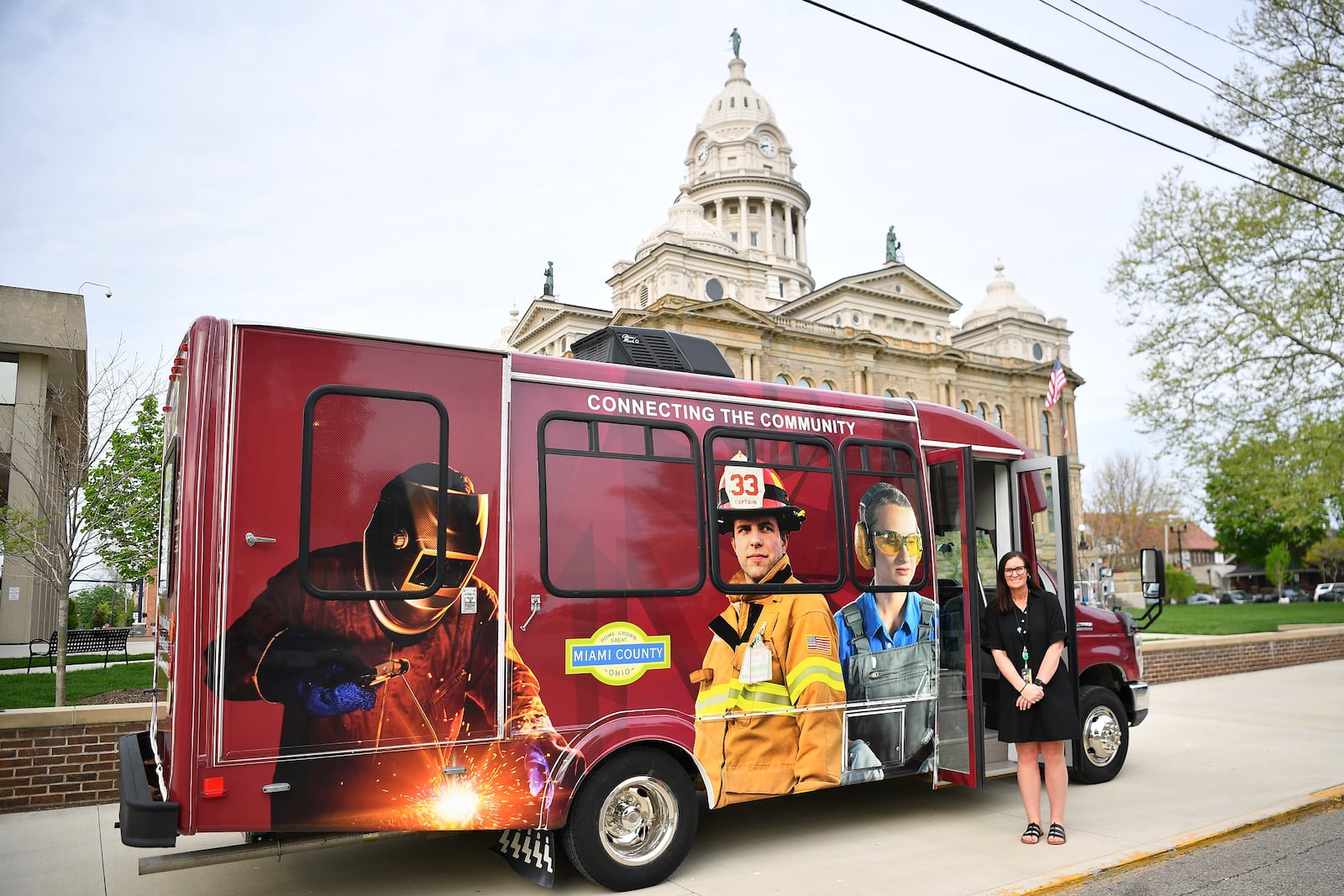 Sara Bowers, Miami County Job and Family Services director, is shown with the department's new mobile unit. Contributed photo.