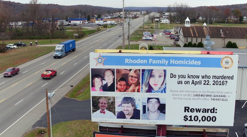 The reward billboard remains after arrests have been made in the Rhoden family slaying case that happened 2½ years ago, putting Pike County residents on edge. TY GREENLEES / STAFF