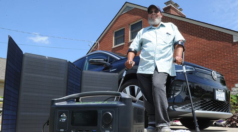 Rap Hankins shows green energy products that will be on display during the Green Expo and Car Cruise-In on Sept. 11. MARSHALL GORBY\STAFF