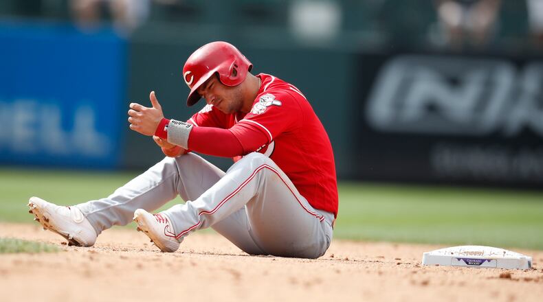 Cincinnati Reds' Jose Iglesias reacts after he was caught trying to steal second base by Colorado Rockies catcher Tony Wolters in the eighth inning of a baseball game Sunday, July 14, 2019, in Denver.(AP Photo/David Zalubowski)