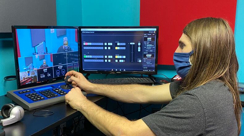 DATV staff member Eric Widing demonstrates how to use the new robotic cameras in DATV's 'Pod Studio'