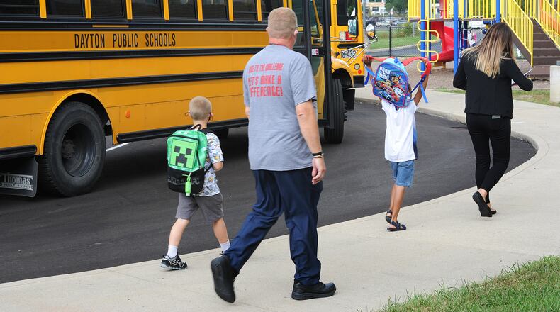 Students at Eastmont elementary in Dayton wait to board the bus at the end of the first day of school on Wednesday Aug. 18, 2021. MARSHALL GORBY\STAFF
