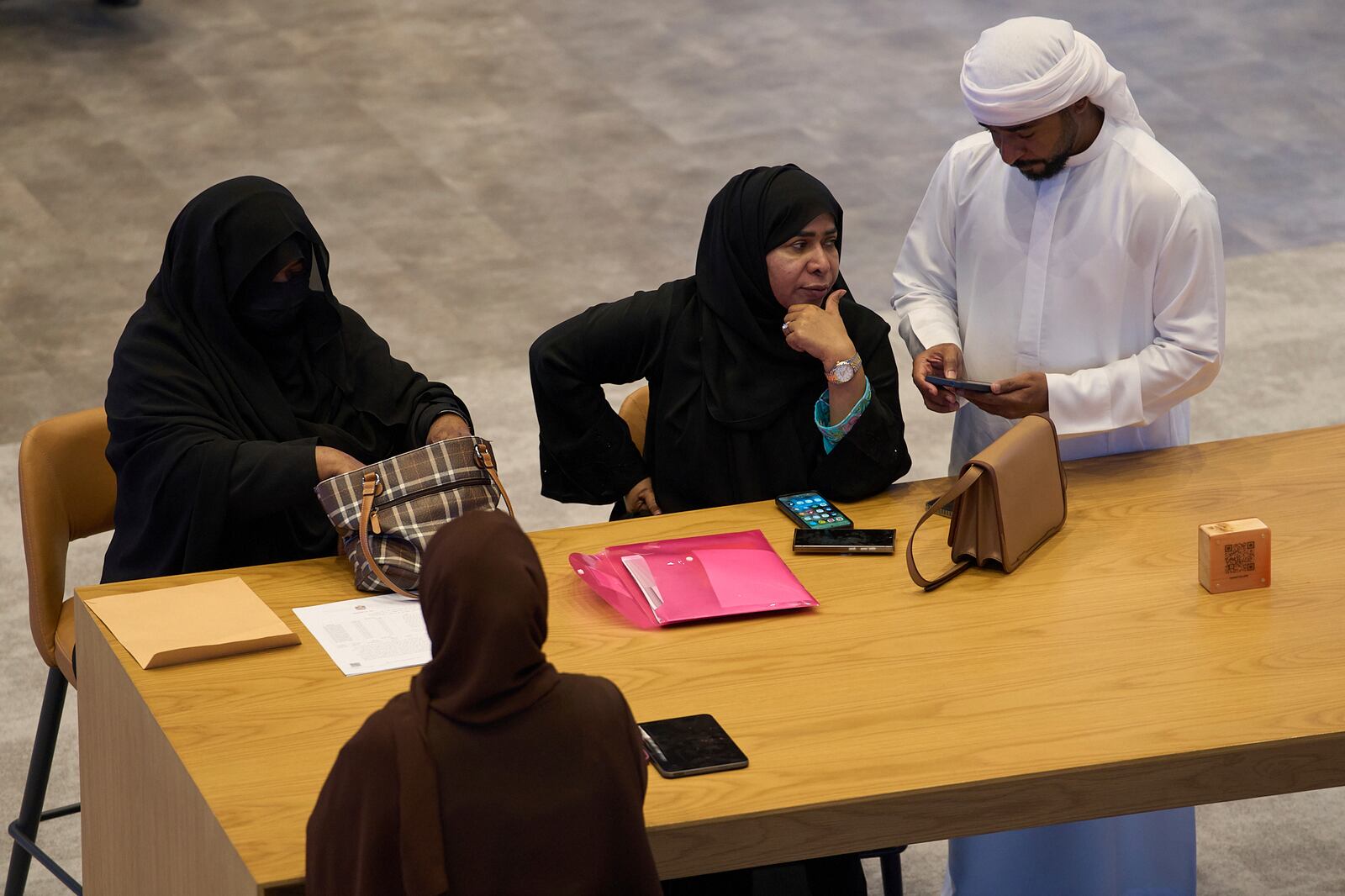 Emiratis are seen in the Dubai Financial Market in Dubai, United Arab Emirates, Monday, April 7, 2025. (AP Photos/Fatima Shbair)