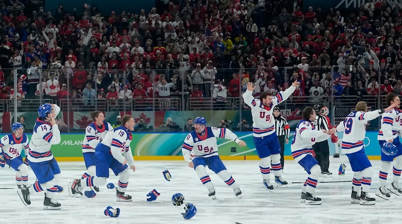 United States players celebrate after defeating Canada during a men's ice hockey gold medal game between Canada and the United States at the 2026 Winter Olympics, in Milan, Italy, Sunday, Feb. 22, 2026. (AP Photo/Petr David Josek)