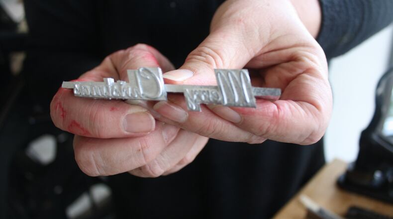 Maria Gossard makes custom cards from a 19th century letterpress at her 2509 Far Hills Ave. shop. KAITLIN SCHROEDER