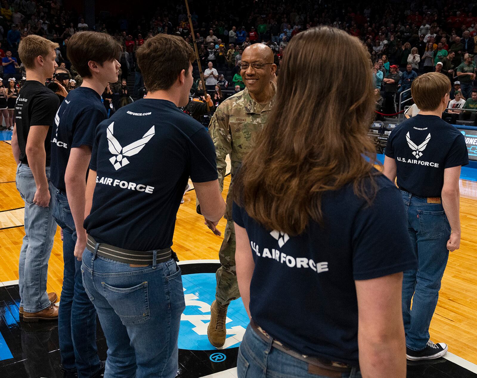 Air Force Chief of Staff Gen. CQ Brown Jr. congratulates new Air Force recruits after administering the oath of enlistment March 16. A group of 24 new Airmen took the oath during halftime of the NCAA men’s basketball tournament game between Wright State and Bryant at Dayton University Arena. U.S. AIR FORCE PHOTO/R.J. ORIEZ