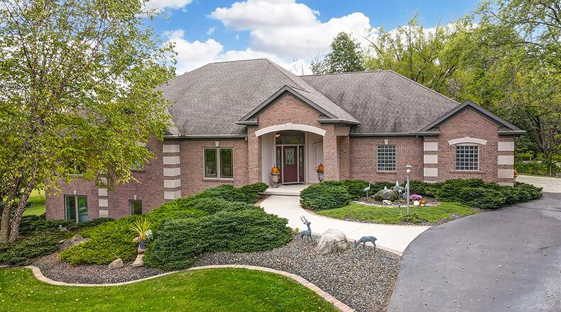 The 4-bedroom, brick home has about 5,410 sq. ft. of living space with a finished, walk-out lower level and 3-car garage. The home, which was built in custom built in 2004, is set on 4.3 acres with a paved, circular drive. CONTRIBUTED PHOTO