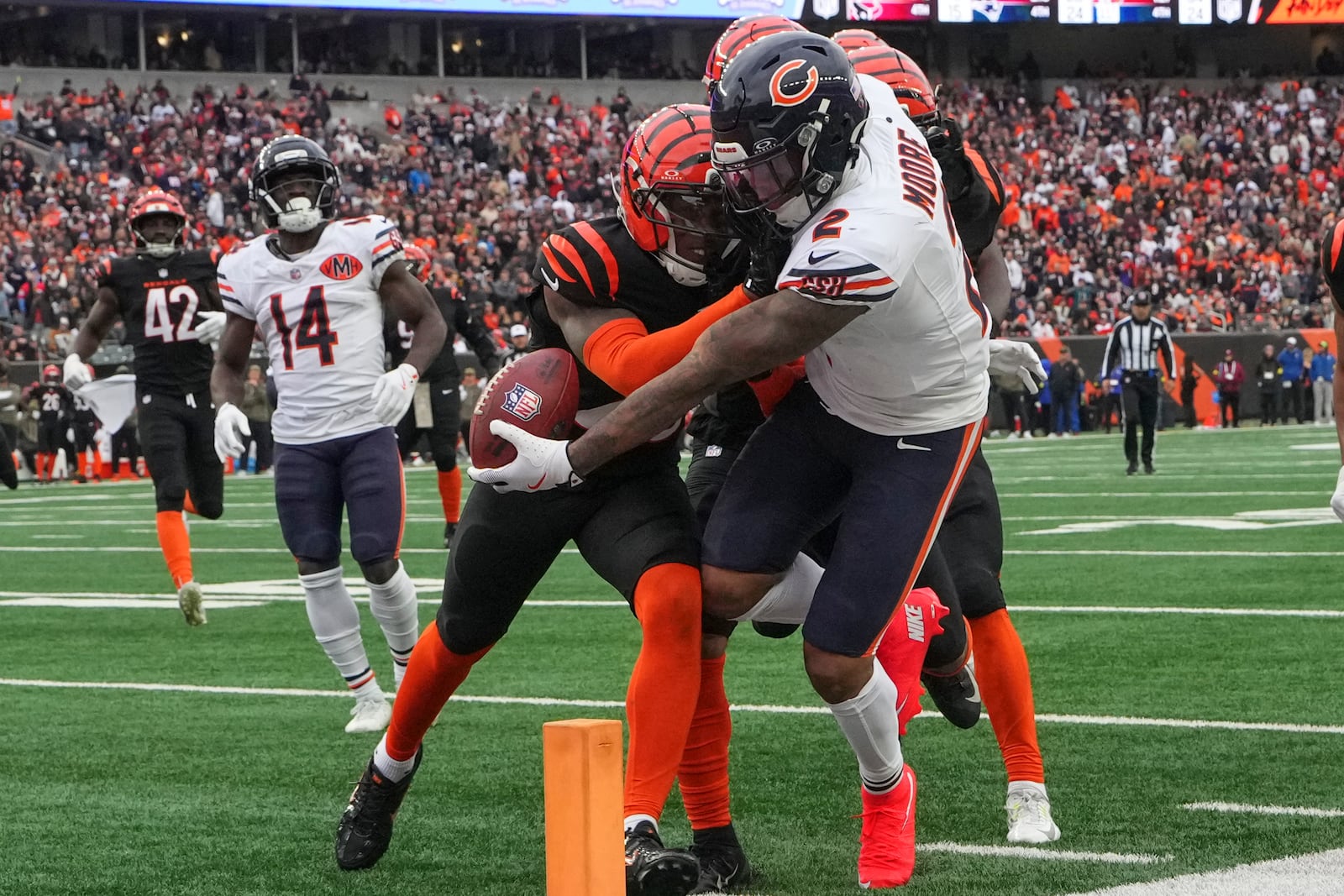 Chicago Bears wide receiver DJ Moore (2) crosses the goal line for a touchdown before dropping the ball during the second half of an NFL football game against the Cincinnati Bengals, Sunday, Nov. 2, 2025, in Cincinnati. (AP Photo/Jeff Dean)