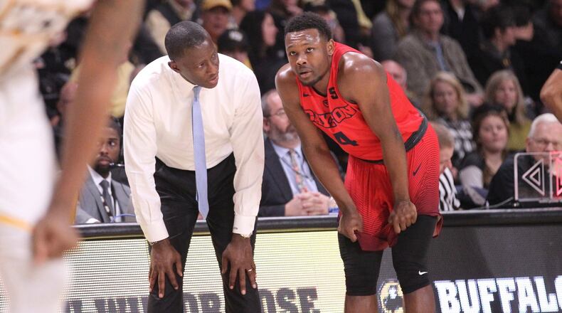 Dayton’s Anthony Grant talks to Jordan Davis during a game against Virginia Commonwealth on Feb. 10, 2018, at the Siegel Center in Richmond, Virginia. DAVID JABLONSKI / STAFF