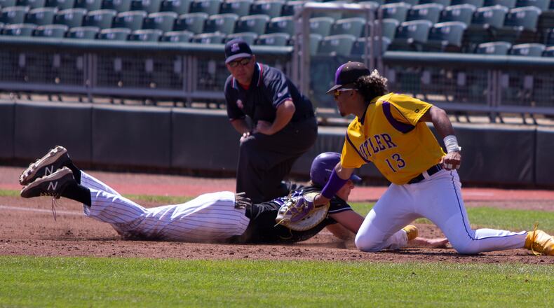 Vandalia Butler's Quin Hamilton tags out an Elder baserunner on a pickoff throw by catcher Boston Smith. Smith picked off two runners Saturday in the Aviators' 4-0 loss in eight innings in the Division I regional final. Jeff Gilbert/CONTRIBUTED