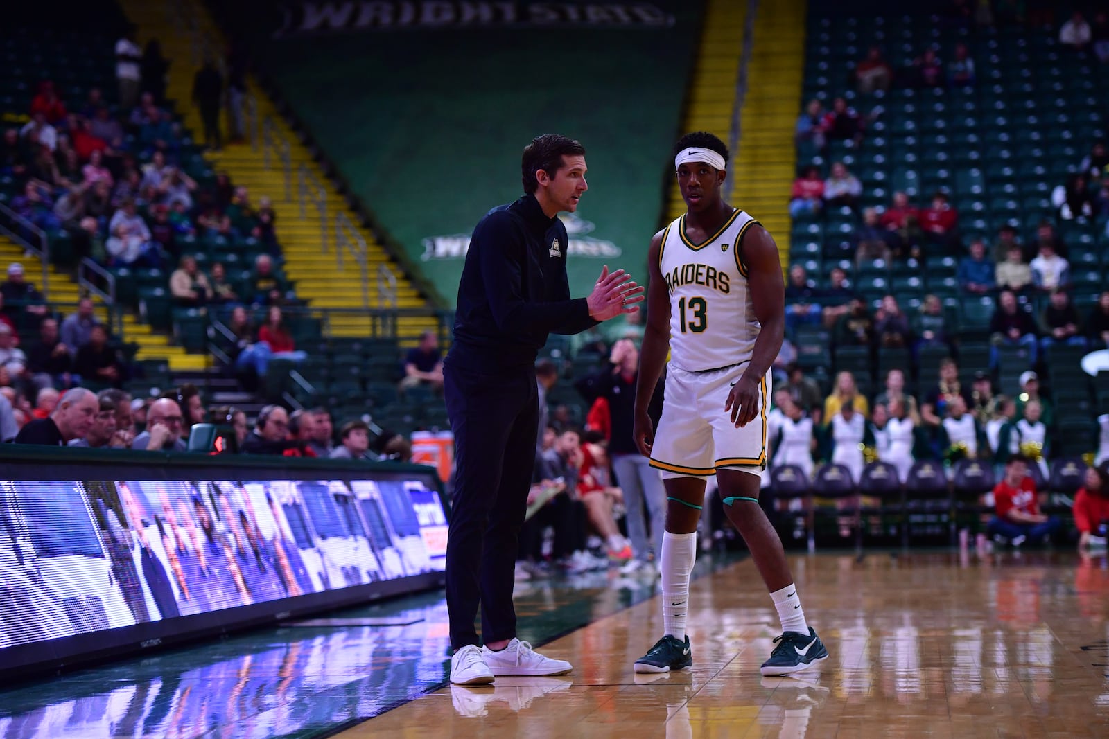 Wright State University's Simon Callaghan talks with Raiders coach Clint Sargent during their game against Miami on Dec. 16 at the Ervin J. Nutter Center in Fairborn. JOSEPH R. CRAVEN / CONTRIBUTED PHOTO