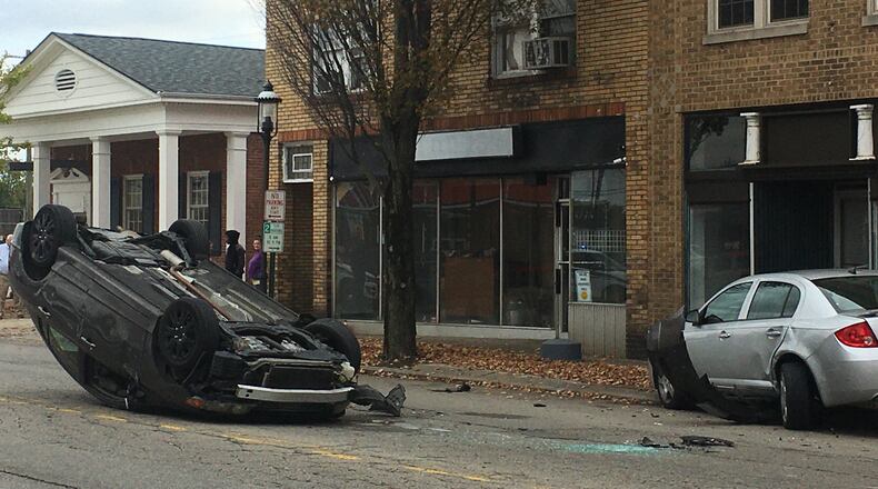 A car flipped on Central Avenue this afternoon after it crashed into a parked car. The female driver was treated and released from the scene. RICK McCRABB/STAFF